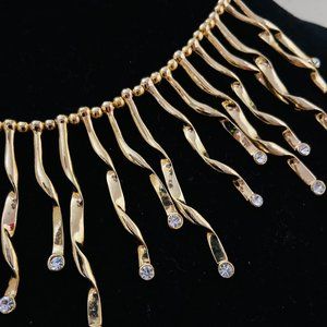 Elegant gold tone and faux diamond necklace. About 16".